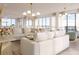 Open concept living and dining area with stunning water views through large windows and modern lighting at 33 S Palm Ave # 1501, Sarasota, FL 34236