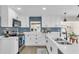 Modern kitchen with blue subway tile backsplash, white cabinets, stainless steel appliances, and wood floors at 3312 33Rd Street Ct W, Bradenton, FL 34205