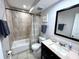 This bathroom features a single sink vanity with a dark wood cabinet, shower and tile flooring at 3473 Clark Rd # 171, Sarasota, FL 34231