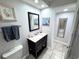 This bathroom features a single sink vanity with a dark wood cabinet, mirror and tile flooring at 3473 Clark Rd # 171, Sarasota, FL 34231