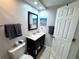 This bathroom features a single sink vanity with a dark wood cabinet, mirror and tile flooring at 3473 Clark Rd # 171, Sarasota, FL 34231