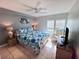 Serene bedroom with tile flooring, ceiling fan, and natural light from the windows at 3473 Clark Rd # 171, Sarasota, FL 34231