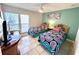 Bright bedroom featuring twin beds, decorative coastal accents and tiled flooring at 3473 Clark Rd # 171, Sarasota, FL 34231