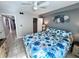 Cozy bedroom with tile flooring, ceiling fan, and direct access to the hallway at 3473 Clark Rd # 171, Sarasota, FL 34231