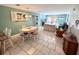 Open-concept dining area with seating for six and views of the adjacent living room at 3473 Clark Rd # 171, Sarasota, FL 34231
