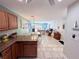 Open living space with tile flooring, kitchen breakfast bar, dining area and living room at 3473 Clark Rd # 171, Sarasota, FL 34231