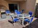 Outdoor patio featuring a large glass table with six chairs and a gas grill at 3473 Clark Rd # 171, Sarasota, FL 34231