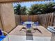 Outdoor patio featuring a round glass table with four chairs and a gas grill at 3473 Clark Rd # 171, Sarasota, FL 34231