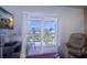 Cozy sitting area with TV and sliding door leading out to an outdoor balcony at 3701 5Th Ave # 1, Holmes Beach, FL 34217
