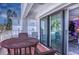 Outdoor balcony with wood table and chairs and sliding door to the unit at 3701 5Th Ave # 1, Holmes Beach, FL 34217