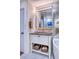 Elegant bathroom vanity with storage baskets, granite counter top, and mirrored medicine cabinet at 3701 5Th Ave # 1, Holmes Beach, FL 34217