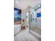 Stunning bathroom with tiled shower and tub, beach-themed mural, and contemporary fixtures at 3701 5Th Ave # 1, Holmes Beach, FL 34217