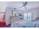 Bright bedroom with dresser, fan, coastal decor, and sliding glass doors at 3701 5Th Ave # 1, Holmes Beach, FL 34217