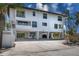 Three-story townhouse showcasing covered parking and well-manicured landscaping at 3701 5Th Ave # 1, Holmes Beach, FL 34217