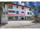 Three-story townhouse showcasing covered parking and well-manicured landscaping at 3701 5Th Ave # 1, Holmes Beach, FL 34217