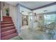 Open floor plan showing the kitchen, dining area, and staircase with carpeted treads at 3701 5Th Ave # 1, Holmes Beach, FL 34217