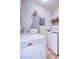 Bright laundry room featuring a Maytag washer and dryer, ironing board, and overhead shelf storage at 3701 5Th Ave # 1, Holmes Beach, FL 34217