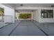 Covered parking area with painted lines, storage, and a bench at 3701 5Th Ave # 1, Holmes Beach, FL 34217