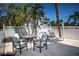 Outdoor patio with stone tile, table and chairs, and lounge chairs at 3701 5Th Ave # 1, Holmes Beach, FL 34217
