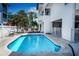 Gorgeous community pool featuring lounge chairs and manicured landscaping at 3701 5Th Ave # 1, Holmes Beach, FL 34217