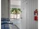 Storage area with locked door, fire extinguisher, and trash bins at 3701 5Th Ave # 1, Holmes Beach, FL 34217