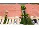 Overhead shot of the townhome with well-kept landscaping, tile roof, and convenient parking spaces at 3784 Parkridge Cir # 22-203, Sarasota, FL 34243