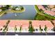 Aerial view shows community features including a pond with fountain, pool, and assigned parking at 3784 Parkridge Cir # 22-203, Sarasota, FL 34243