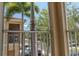 View from balcony overlooking street, palm trees, and neighborhood buildings on a sunny day at 3784 Parkridge Cir # 22-203, Sarasota, FL 34243