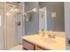 Well-lit bathroom featuring a shower, sink, wood vanity, and neutral-toned walls at 3784 Parkridge Cir # 22-203, Sarasota, FL 34243