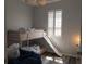 Comfortable bedroom with a bunk bed, wood floors and a window with white blinds at 3784 Parkridge Cir # 22-203, Sarasota, FL 34243