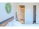 Relaxing bedroom features a leafy wreath, minimalist art, and a view into a shower at 3784 Parkridge Cir # 22-203, Sarasota, FL 34243