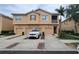 Attractive townhome with private garage, landscaped driveway, and charming architectural details at 3784 Parkridge Cir # 22-203, Sarasota, FL 34243