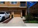 Townhouse exterior featuring a driveway, two-car garage, and well-maintained landscaping at 3784 Parkridge Cir # 22-203, Sarasota, FL 34243