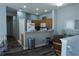 View of the living room and kitchen, with hard surface floors, and blue walls at 3784 Parkridge Cir # 22-203, Sarasota, FL 34243