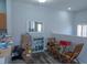 Cozy sitting area with wood floors, small table and chairs and storage at 3784 Parkridge Cir # 22-203, Sarasota, FL 34243