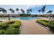 Community pool with comfortable lounge chairs, lush landscaping, and ample space for relaxation at 3784 Parkridge Cir # 22-203, Sarasota, FL 34243