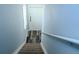 View from the top of the stairs to the front door with luxury vinyl plank flooring at 3784 Parkridge Cir # 22-203, Sarasota, FL 34243