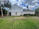 Spacious backyard featuring well-maintained lawn, mature palm trees, and partial house view at 4111 34Th St E, Bradenton, FL 34208