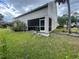 View of the backyard with a screened-in lanai and lush green lawn at 4111 34Th St E, Bradenton, FL 34208