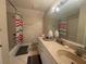 A simple bathroom with a shower-tub combo, tile flooring, and essential fixtures at 4111 34Th St E, Bradenton, FL 34208
