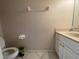 A basic half bath with a single vanity, toilet, and minimal décor at 4111 34Th St E, Bradenton, FL 34208