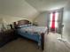 Comfortable bedroom with carpet flooring, a large bed, and natural light at 4111 34Th St E, Bradenton, FL 34208