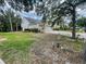 Home exterior with a two-car garage, mature landscaping, and a long driveway at 4111 34Th St E, Bradenton, FL 34208