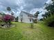 A well-manicured lawn with blooming shrubbery surrounds the side of the residence at 4111 34Th St E, Bradenton, FL 34208