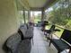 A screened patio with comfortable seating, overlooking a serene outdoor setting at 4111 34Th St E, Bradenton, FL 34208