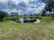 Scenic view of community pond reflecting the sky with lush landscaping in the background at 4111 34Th St E, Bradenton, FL 34208