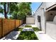 A spacious backyard with a combination of concrete pads and artificial turf with a wooden fence at 4347 9Th N Ave, St Petersburg, FL 33713
