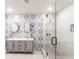 A stylish bathroom with dual sinks, vessel bowls, decorative wallpaper, and a glass-enclosed shower at 4347 9Th N Ave, St Petersburg, FL 33713
