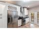 Modern kitchen boasts stainless steel appliances, granite counters, and subway tile backsplash, with french door access to yard at 4347 9Th N Ave, St Petersburg, FL 33713