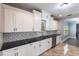 Updated kitchen features white cabinets, granite countertops, stainless steel appliances and subway tile backsplash at 4347 9Th N Ave, St Petersburg, FL 33713
